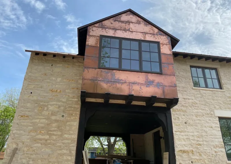 Copper metal panel facade on a stone building for Skylight Installation in Russellville