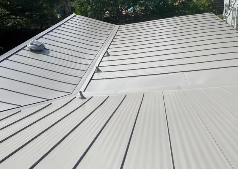 Solar attic fan installed on a metal roof for Roof Ventilation in Russellville
